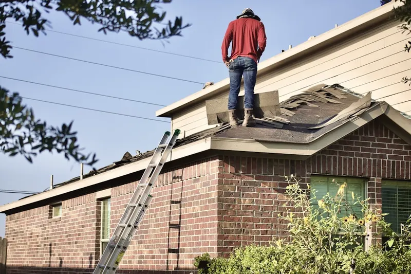 Professional roofer working on a residential roof in Wormsers